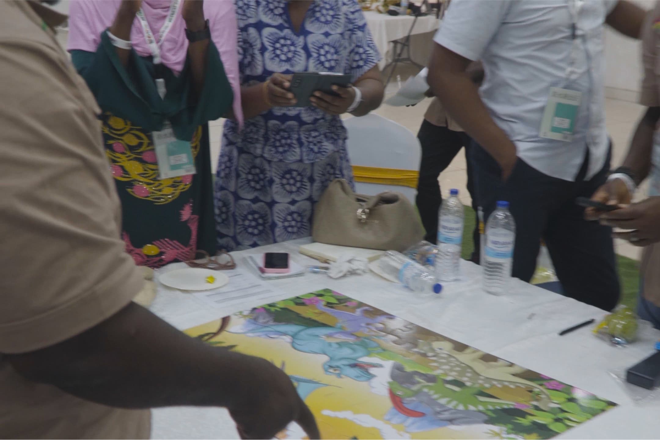 Retreat participants working around a table with an illustrated map